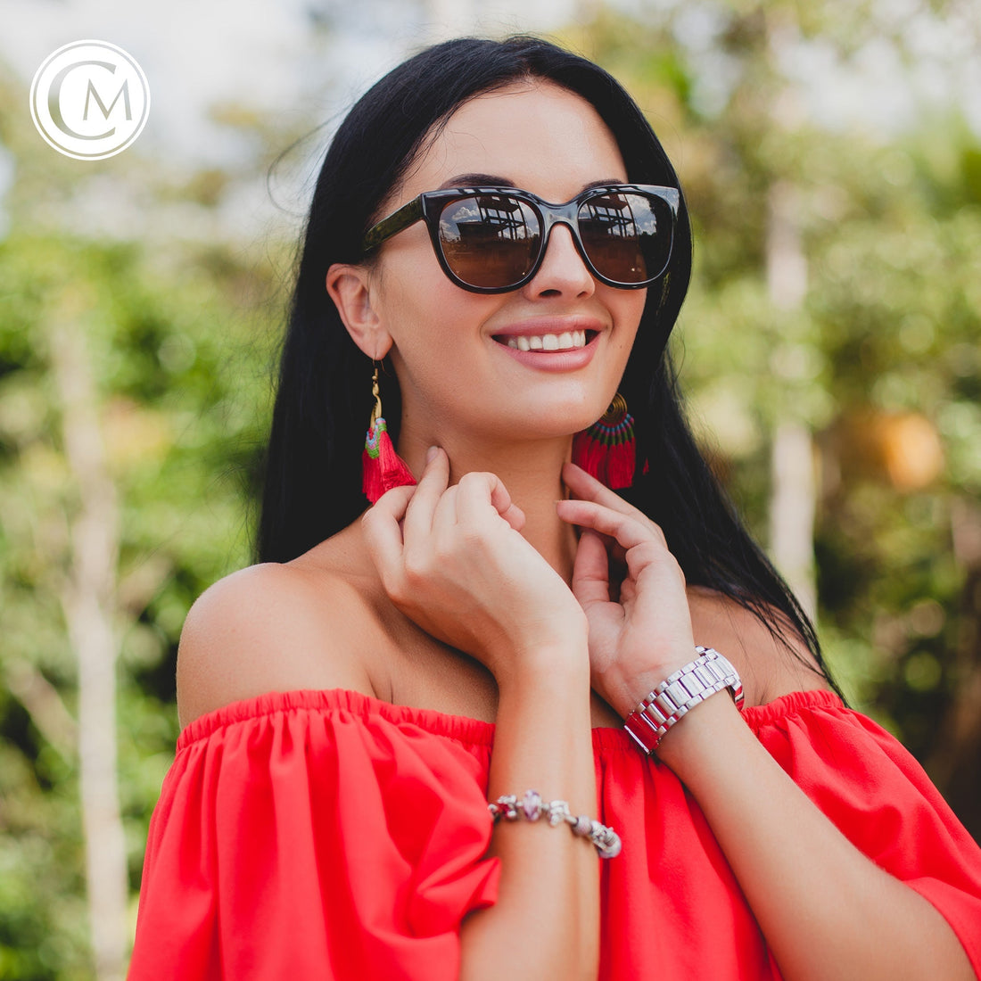 Woman in orange dress with silver jewelry and sunglasses